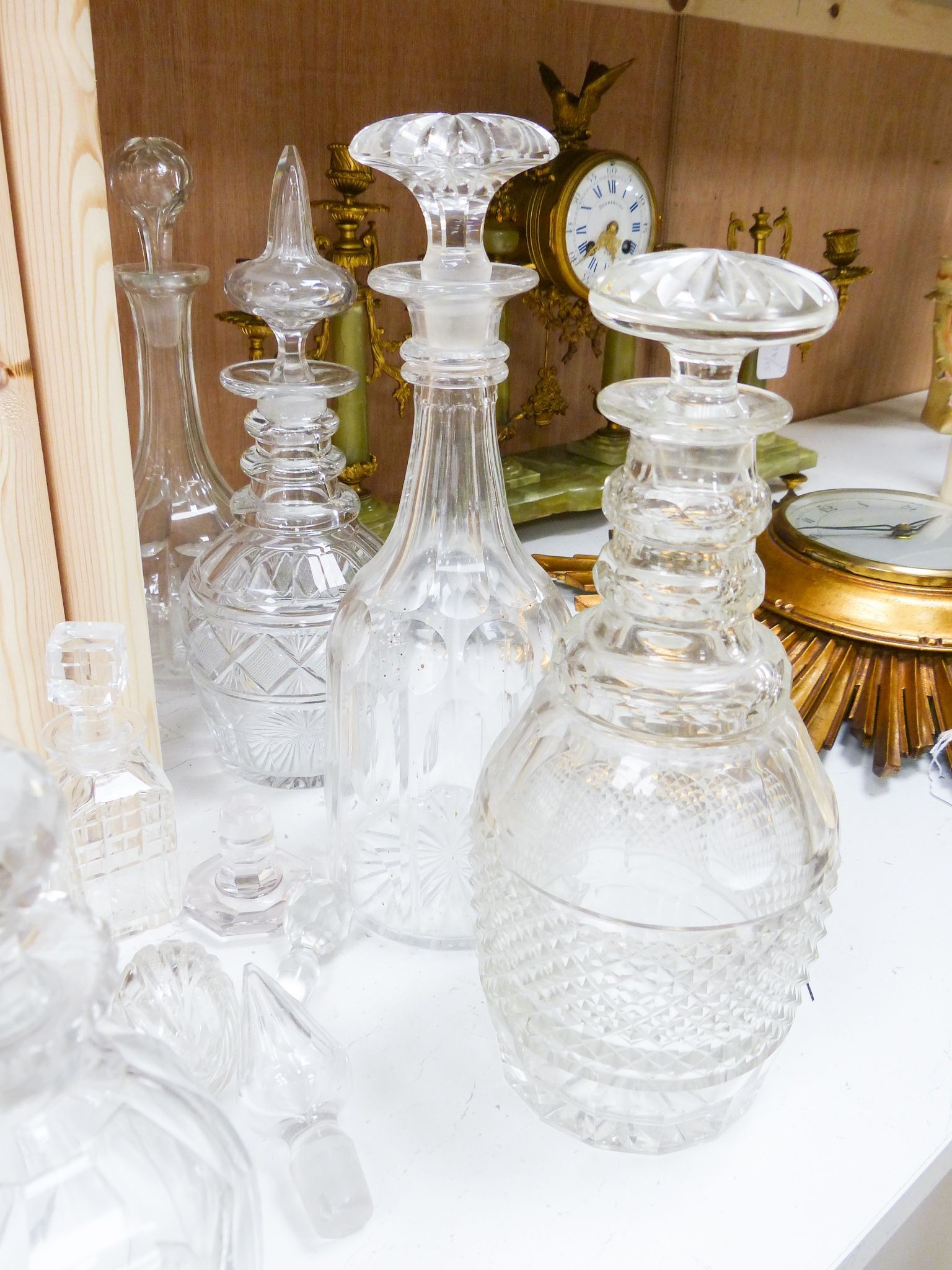 A collection of thirteen cut glass decanters